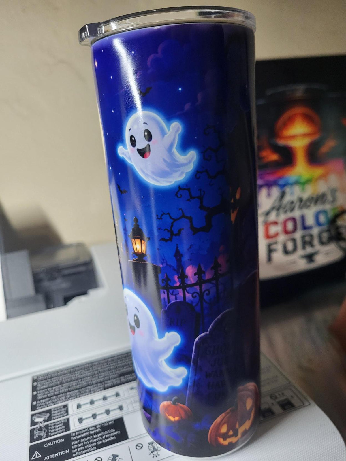 Halloween ghost tumbler front view with haunted mansion and ghost holding lollipop under full moon