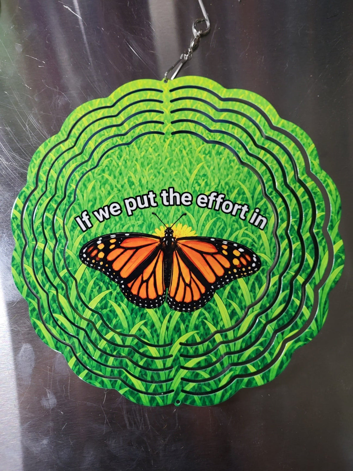 Wind spinner back side showing monarch butterfly with quote If we put the effort in