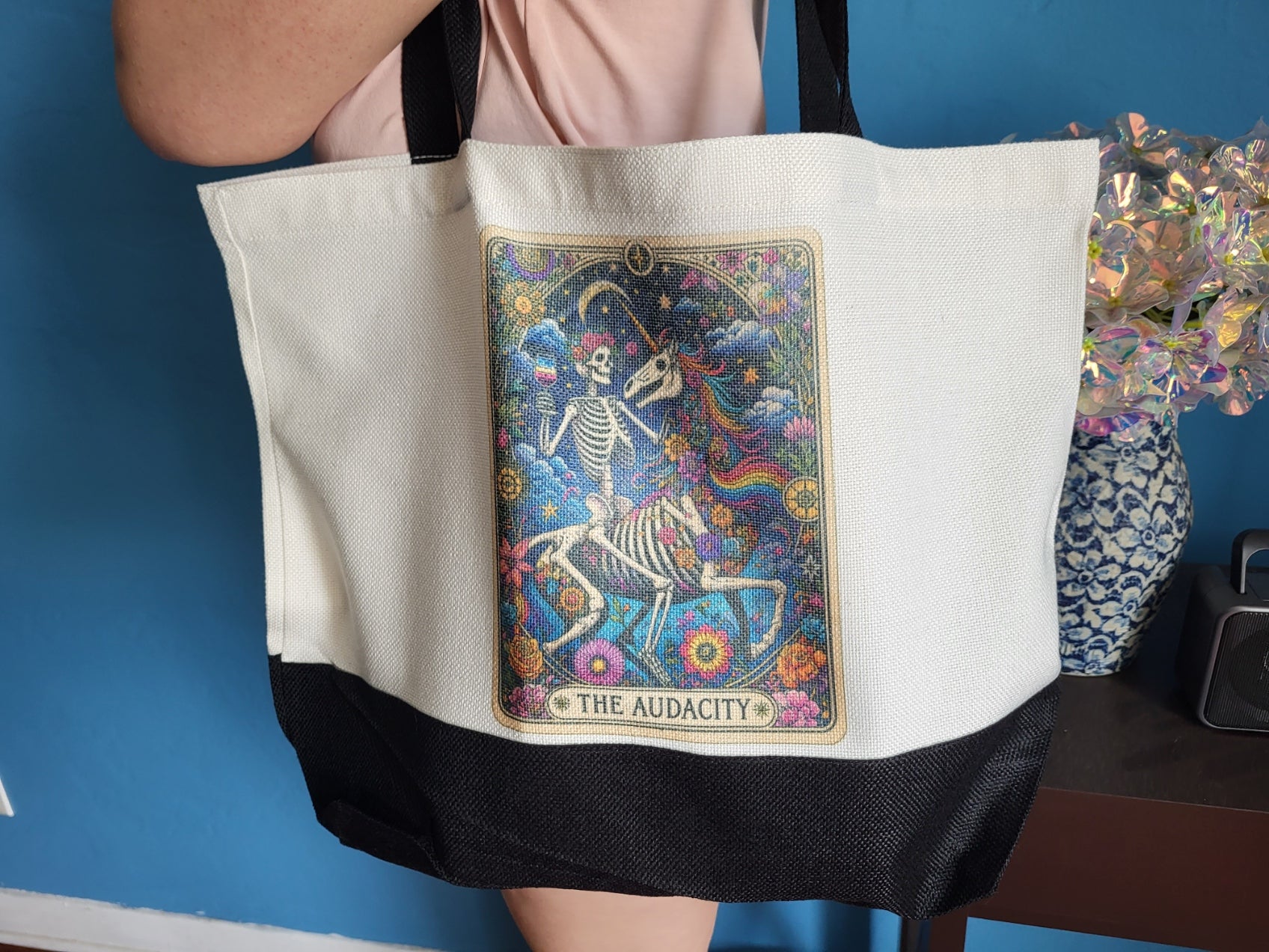 Tote bag with dandelion No Matter What I Will Thrive design, held by model