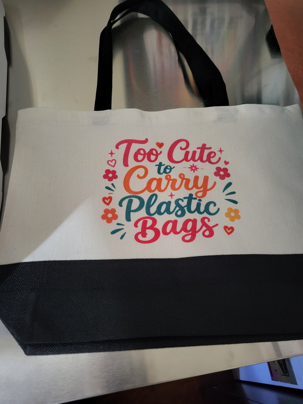 Tote bag with Too Cute to Carry Plastic Bags design, flat lay